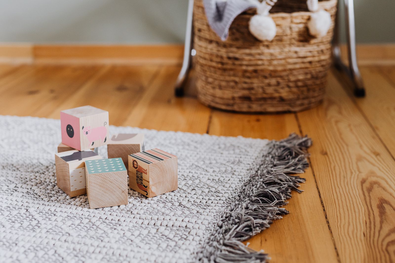 A clean, neutral children's play area with a wipe-clean foam mat and soft removable-cover seating